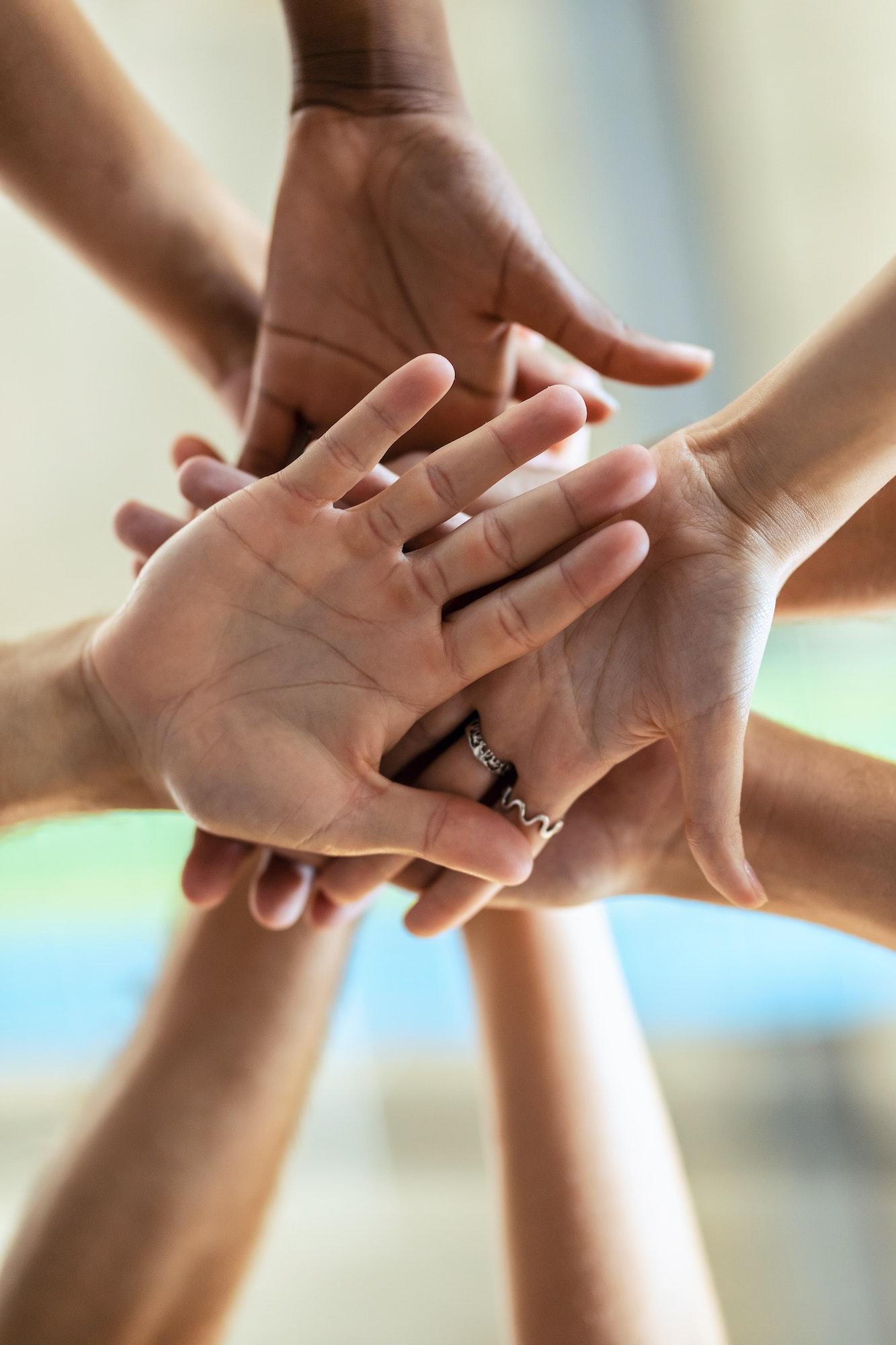 Hands of successful smart business team celebrating good job while holding up their right hands